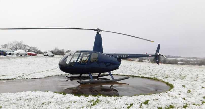Robinson R44 on the pad ready to charter