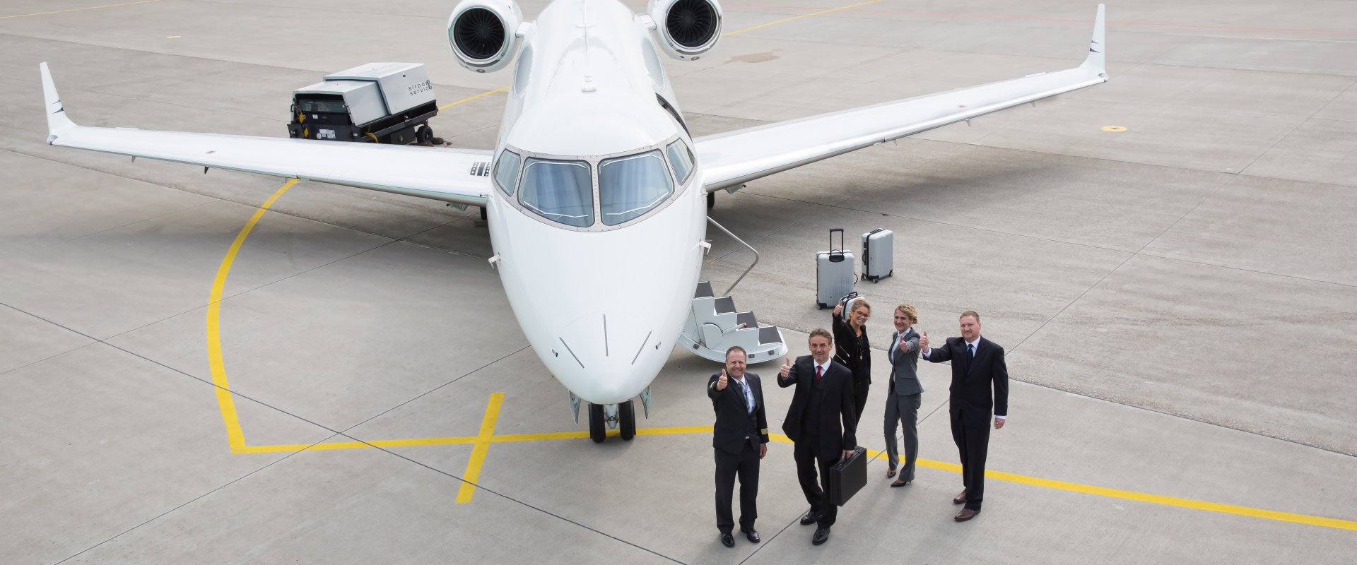 Private jet team Glasgow on the airport apron with a jet