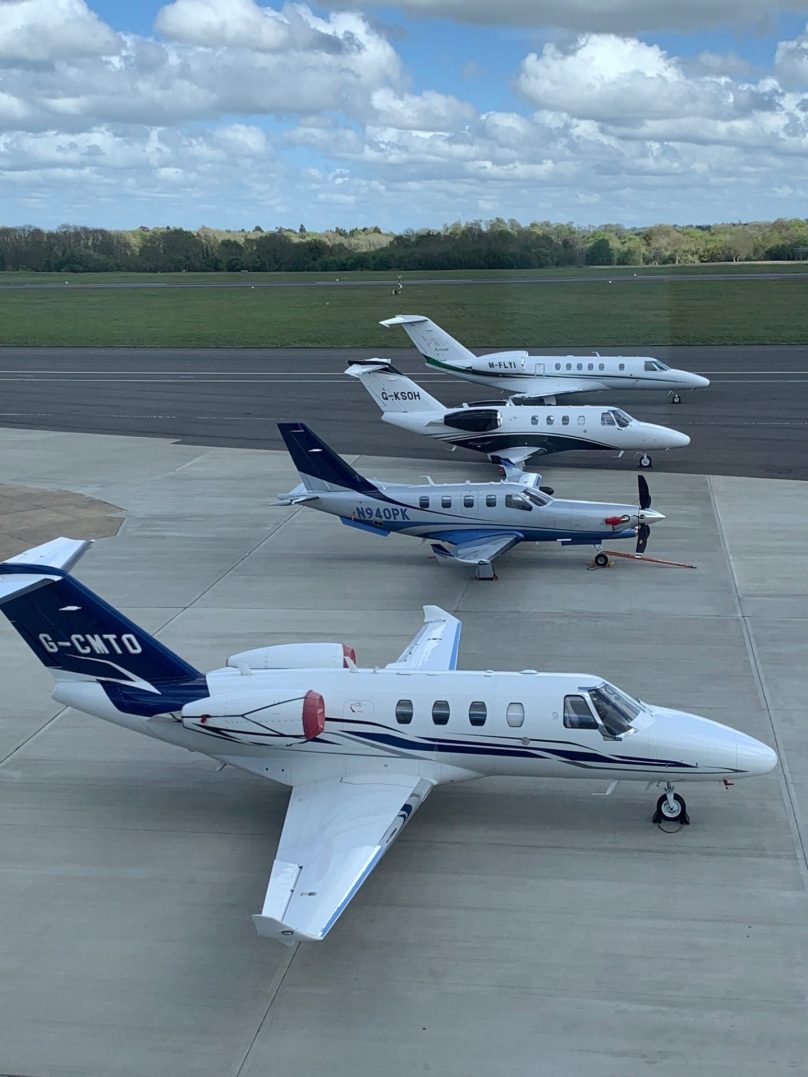 Private jets lined up on the airport apron