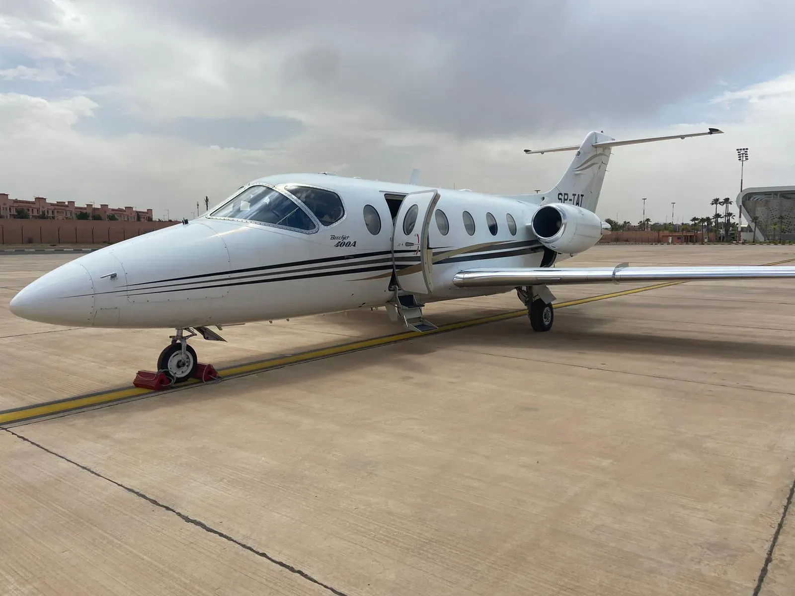 e555923a-0157-41ca-8da1-6844118d9f0bwebp ► Charter-A Ltd Charter-a ltd private jet parked on an airport tarmac under a cloudy sky.